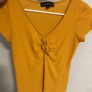Mustard colored cinched crop top from zumiez